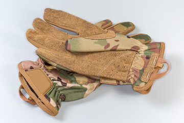 Wall Mural - Beige tactical military gloves on a gray background
