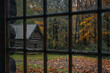 Rainy day in the forest, rain drops on the window of a wooden cottage