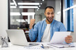 © Tetiana - Joyful Indian businessman celebrating success in office