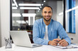 © Tetiana - Smiling Indian businessman working in a modern office
