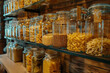 Different kinds of pasta in glass jars on shelves
