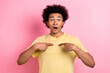 Photo of excited funky man wear yellow t-shirt pointing two fingers herself open mouth isolated pink color background