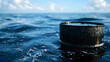 Oil barrel or oil tank and oil on the ocean surface with blue sky background, water pollution and chemicals create problems for the environment concept