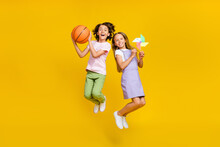 Full Length Photo Of Funky Excited Friends Wear Casual Outfits Jumping High Enjoying Hobbies Isolated Yellow Color Background