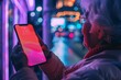 App demo near shoulder of a senior woman holding an smartphone with a fully neon screen