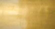 Gold wall texture background. Yellow shiny gold foil paper sheet surface, vibrant golden luxury wallpaper