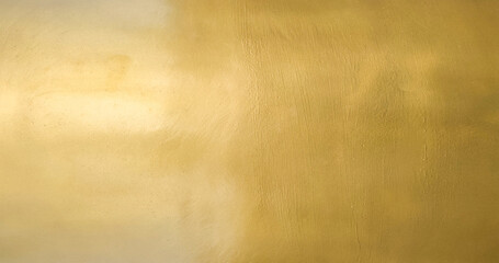 Wall Mural - Gold wall texture background. Yellow shiny gold foil paper sheet surface, vibrant golden luxury wallpaper