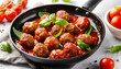 Frying pan of tasty meat balls with tomato sauce and basil on white background