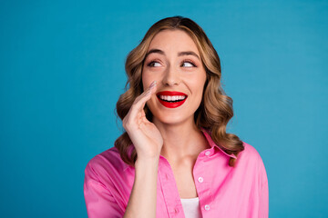 Sticker - Photo portrait of lovely young lady look empty space share secret dressed stylish pink garment hairdo isolated on blue color background