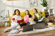 Three interracial teenage girls engrossed in studying with books and laptops on a cozy couch, embodying friendship and education.