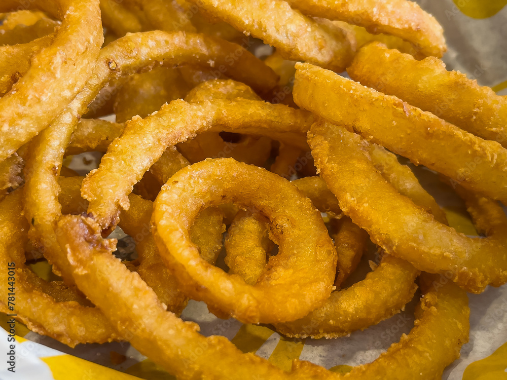 Onion Rings Paper Macro of golden, fried onion rings in white wax paper lined basket ...