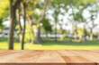 Wooden table top on blur nature bokeh green park background. Empty Wooden tabletop used for advertising products or products