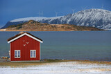 Fototapeta Sawanna - Winter landscape with red boathouse near Alesund, Norway.