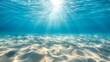 Serene underwater view with sunlight filtering down to the sandy ocean floor