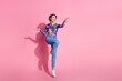 © deagreez - Full size photo of nice young woman jump show empty space wear pullover isolated on pink color background