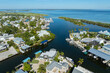 Wealthy neighborhood in small town Boca Grande, Florida with expensive waterfront houses between green palm trees. Development of US premium housing