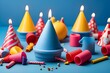 Different bright birthday party hats with pompoms on blue background,party hats and confetti