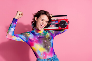 Poster - Photo of nice young woman boombox raise fist wear pullover isolated on pink color background