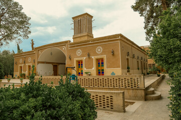 Old traditional adobe house with a wind catching tower in Yazd, Iran