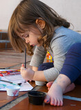 Fototapeta  - 
Little girl drawing and painting, outdoors.