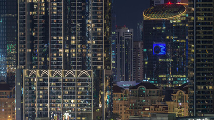 Wall Mural - Aerial nighttime cityscape with illuminated architecture of Dubai downtown timelapse, United Arab Emirates.