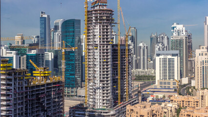 Wall Mural - Construction activity in Dubai downtown with cranes and workers timelapse, UAE.