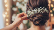 Young Bride Getting Her Hair Done Before Wedding By Professional Hair Stylist With Elegant White Flowers Decorated On Her Hair. With Copy Space.