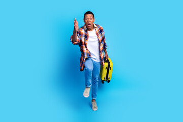 Canvas Print - Full size photo of nice young man suitcase running raise arm catch wear shirt isolated on blue color background