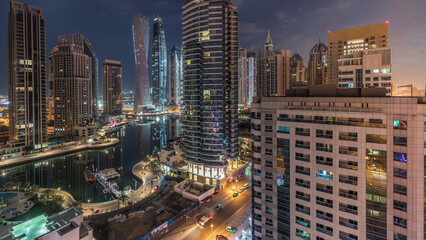 Wall Mural - Aerial view of Dubai Marina residential and office skyscrapers with waterfront night to day timelapse