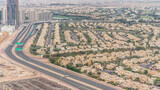 Fototapeta Miasto - Aerial view of apartment houses and villas in Dubai city timelapse, United Arab Emirates