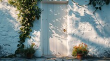 Exterior Of A White Mediterranean Style House With White Door. Traditional Patio Of Greece
