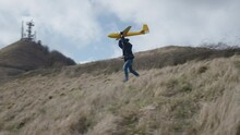 A Yellow Toy Plane Is Launched Into Flight