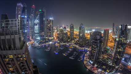 Wall Mural - Aerial top view of Dubai Marina night timelapse. Modern towers and traffic on the road