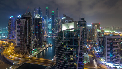 Wall Mural - Aerial view of Dubai Marina residential and office skyscrapers with waterfront night timelapse hyperlapse