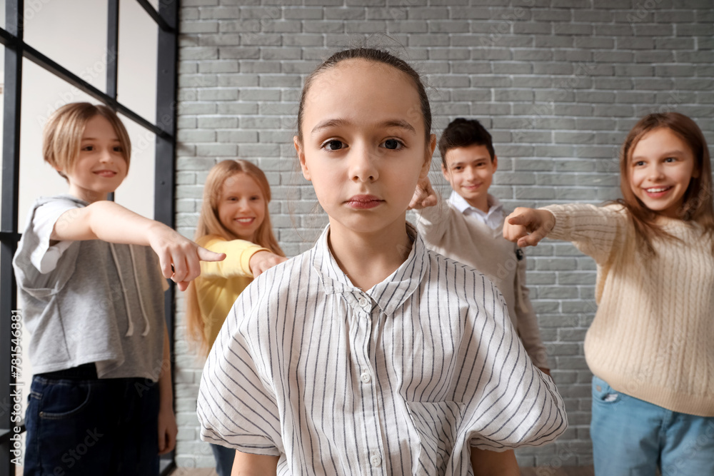 Bullied little girl at school, closeup