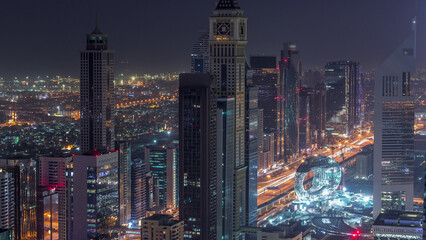 Wall Mural - Skyline of the buildings of Sheikh Zayed Road and DIFC aerial night to day timelapse in Dubai, UAE.