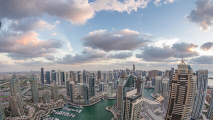 Wall Mural - Dubai Marina skyscrapers and jumeirah lake towers view from the top aerial day to night timelapse in the United Arab Emirates.