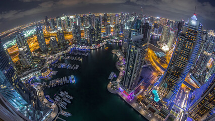 Wall Mural - Dubai Marina skyscrapers and jumeirah lake towers view from the top aerial night timelapse in the United Arab Emirates.