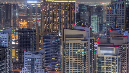 Wall Mural - Dubai Marina skyscrapers and jumeirah lake towers view from the top aerial night timelapse in the United Arab Emirates.