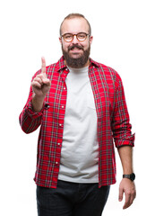 Sticker - Young caucasian hipster man wearing glasses over isolated background showing and pointing up with finger number one while smiling confident and happy.