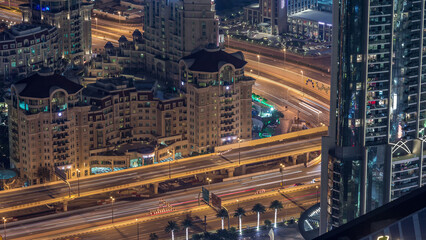 Wall Mural - Aerial view of highway interchange in Dubai downtown evening timelapse.