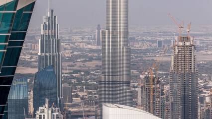 Wall Mural - Panoramic aerial view of downtown towers from business bay in Dubai at evening timelapse.