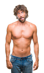 Canvas Print - Handsome hispanic model man sexy and shirtless over isolated background sticking tongue out happy with funny expression. Emotion concept.