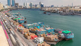 Fototapeta Miasto - Loading a ship in port timelapse in Dubai, Deira creek, UAE.