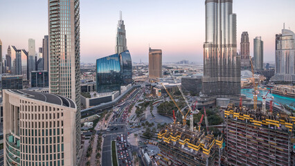 Canvas Print - Panoramic skyline view of Dubai downtown after sunset with mall, fountains and skyscrapers aerial day to night timelapse