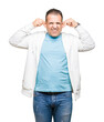 © Krakenimages.com - Middle age arab man wearing sweatshirt over isolated background Smiling pulling ears with fingers, funny gesture. Audition problem