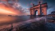 Mumbai. The stone arch of India's Gateway shines at sunrise with the Arabian Sea in view