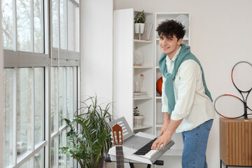 Sticker - Male student playing synthesizer at home