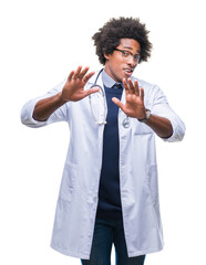 Canvas Print - Afro american doctor man over isolated background afraid and terrified with fear expression stop gesture with hands, shouting in shock. Panic concept.