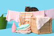 Cute cat with hanging laundry on blue background